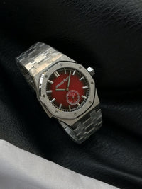 Audemars Piguet Royal Oak with a red dial and integrated bracelet.