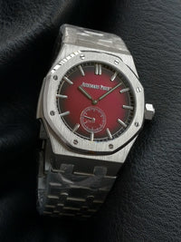 Audemars Piguet Royal Oak with a red dial and integrated bracelet.