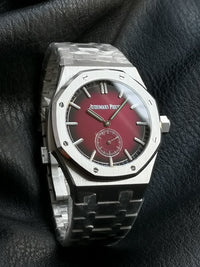 Audemars Piguet Royal Oak with a red dial and integrated bracelet.