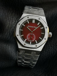 Audemars Piguet Royal Oak with a red dial and integrated bracelet.