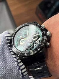 The watch in the image is a custom Rolex Cosmograph Daytona Carbon Fiber Skeleton Edition.